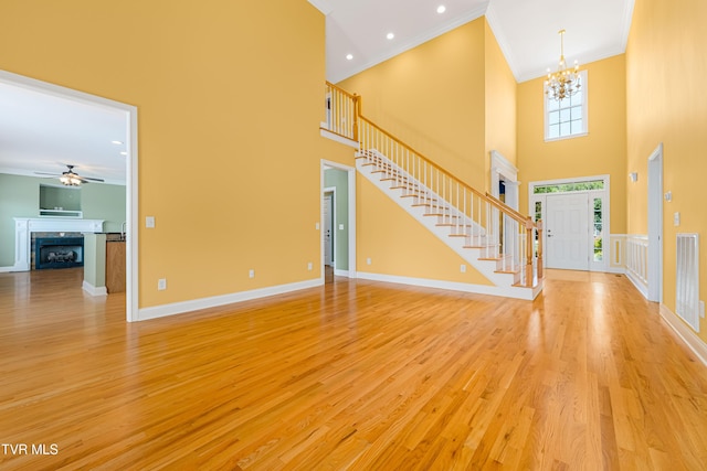 2003 Hackberry Dr, Jonesborough, TN 37659 - entrance foyer featuring ornamental molding, a chandelier, light wood-style flooring, a towering ceiling, and stairs