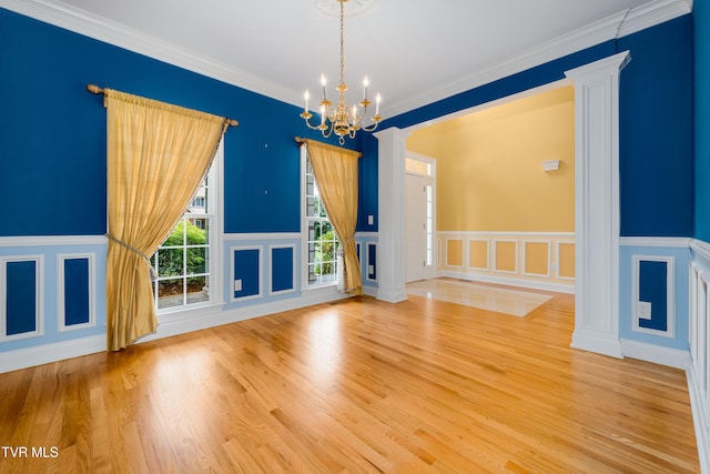 2003 Hackberry Dr, Jonesborough, TN 37659 - unfurnished room featuring a chandelier, decorative columns, a decorative wall, wood finished floors, and a wainscoted wall