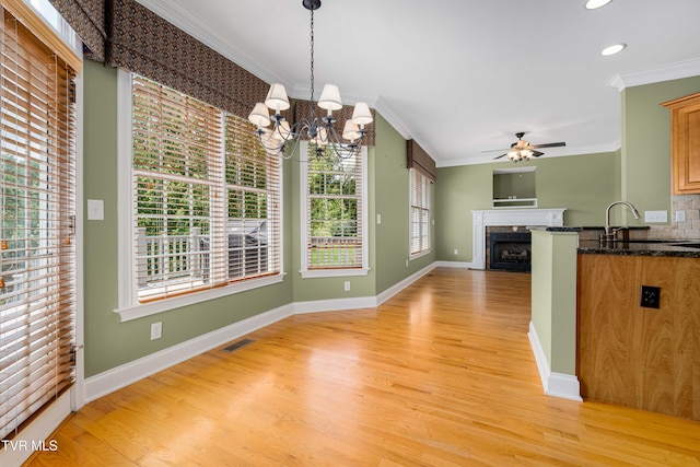 2003 Hackberry Dr, Jonesborough, TN 37659 - kitchen featuring crown molding, light wood-type flooring, a chandelier, ceiling fan, and healthy amount of natural light