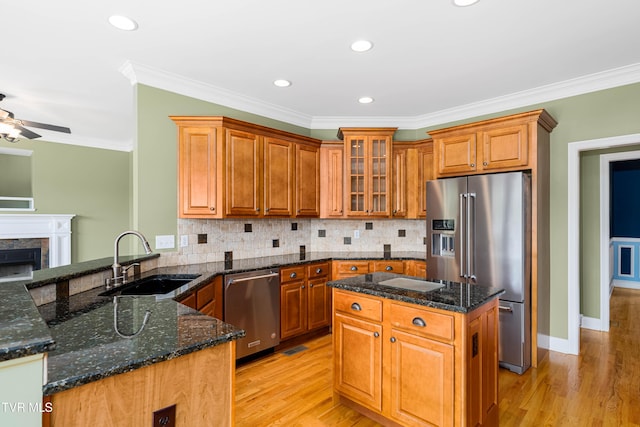 2003 Hackberry Dr, Jonesborough, TN 37659 - kitchen featuring stainless steel appliances, a ceiling fan, light wood-type flooring, ornamental molding, and brown cabinetry