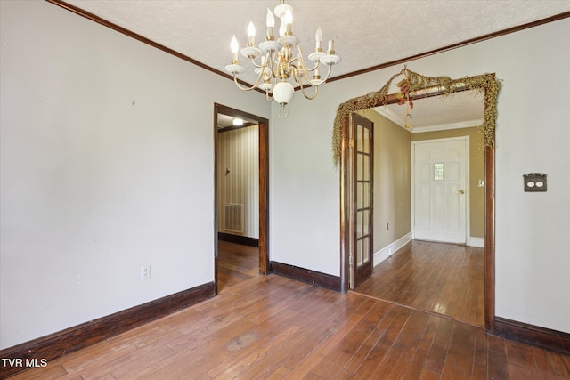 15493 Siesta Ave, Bristol, VA 24202 - empty room with a chandelier, crown molding, a textured ceiling, and hardwood / wood-style flooring