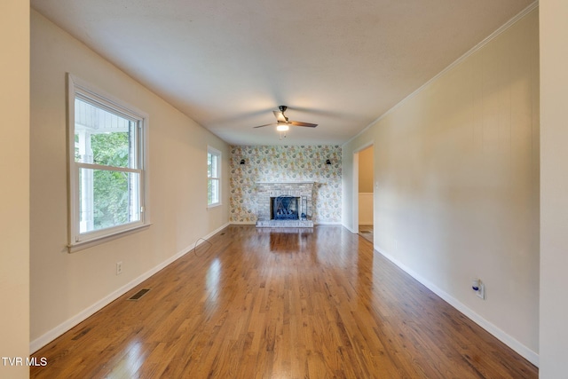 3513 Crest Rd, Kingsport, TN 37664 - unfurnished living room with a ceiling fan, wood finished floors, a stone fireplace, and ornamental molding