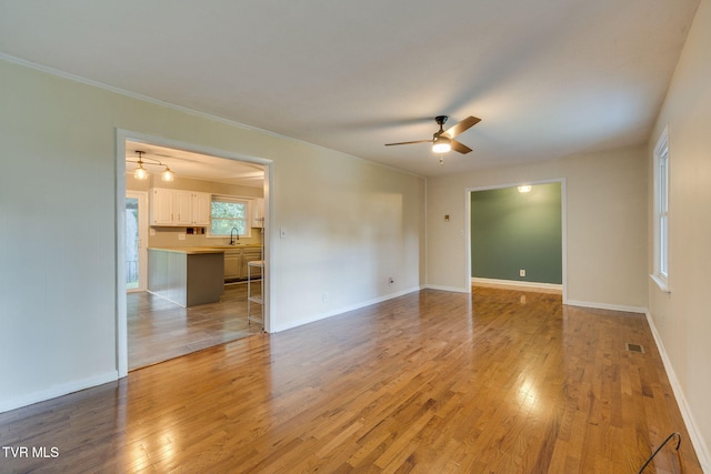 3513 Crest Rd, Kingsport, TN 37664 - unfurnished room with light wood finished floors, ceiling fan, and ornamental molding