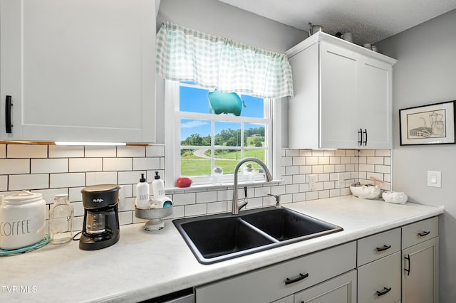 563 Old Jonesboro Rd, Bristol, TN 37620 - kitchen featuring white cabinetry, light countertops, and backsplash