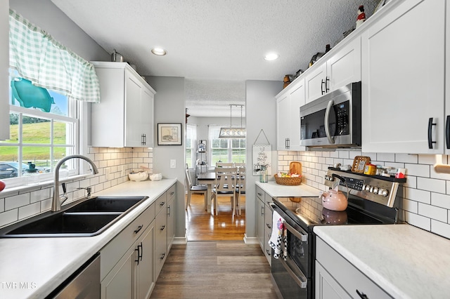 563 Old Jonesboro Rd, Bristol, TN 37620 - kitchen featuring stainless steel appliances, wood finished floors, a textured ceiling, recessed lighting, and light countertops