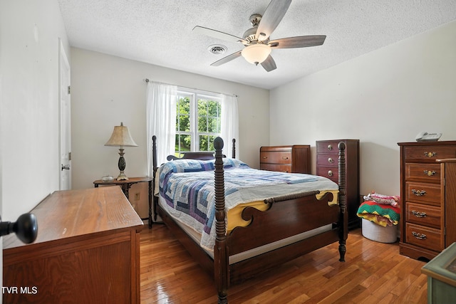 563 Old Jonesboro Rd, Bristol, TN 37620 - bedroom with wood-type flooring, a ceiling fan, and a textured ceiling