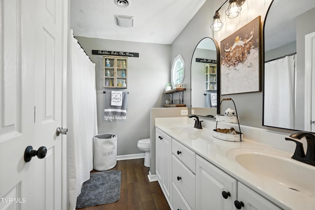 563 Old Jonesboro Rd, Bristol, TN 37620 - full bathroom with a textured ceiling, double vanity, and wood finished floors