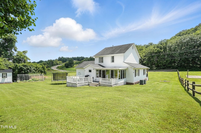 563 Old Jonesboro Rd, Bristol, TN 37620 - rear view of house with a trampoline, a shingled roof, a deck, a sunroom, and an outdoor structure