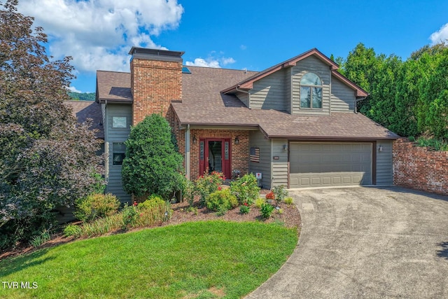223 Willowbend Ct, Kingsport, TN 37660 - view of front of house with a shingled roof, an attached garage, concrete driveway, a front lawn, and a chimney