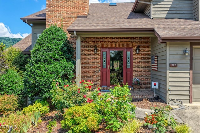 223 Willowbend Ct, Kingsport, TN 37660 - entrance to property with a shingled roof, a chimney, brick siding, and an attached garage