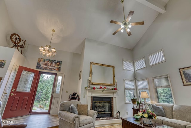 223 Willowbend Ct, Kingsport, TN 37660 - living room featuring high vaulted ceiling, light wood finished floors, a tiled fireplace, a chandelier, and a ceiling fan