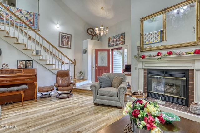 223 Willowbend Ct, Kingsport, TN 37660 - living room with high vaulted ceiling, wood finished floors, a fireplace, a chandelier, and stairs