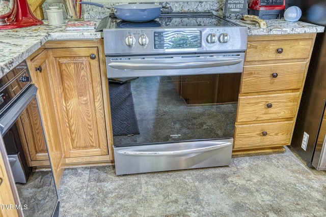 223 Willowbend Ct, Kingsport, TN 37660 - kitchen with stainless steel electric stove, light countertops, and brown cabinetry
