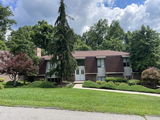 1232 Caribbean Dr, Kingsport, TN 37660 - view of front of house featuring brick siding, a front lawn, french doors, and roof with shingles