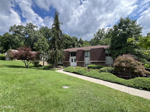 1232 Caribbean Dr, Kingsport, TN 37660 - view of front of home featuring a front lawn, brick siding, and roof with shingles