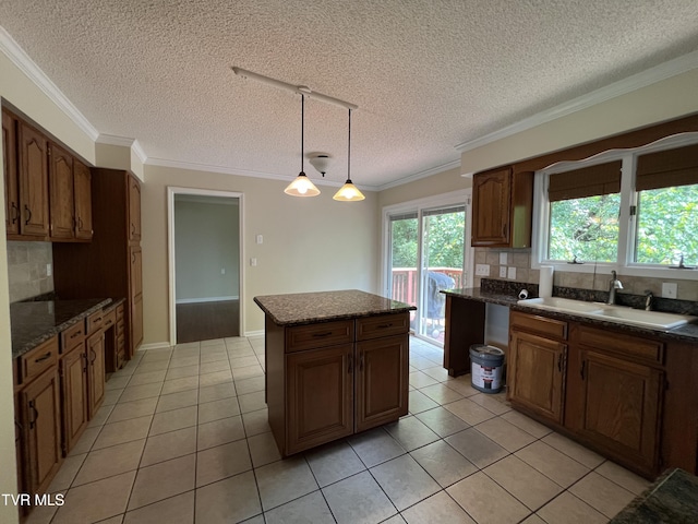 1232 Caribbean Dr, Kingsport, TN 37660 - kitchen featuring a textured ceiling, decorative backsplash, light tile patterned floors, ornamental molding, and a kitchen island