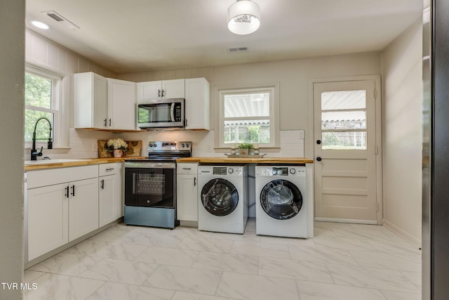 203 Hickory Rd, Bristol, TN 37620 - washroom with light marble finish flooring, washer and clothes dryer, and plenty of natural light