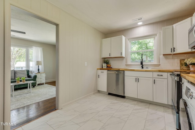 203 Hickory Rd, Bristol, TN 37620 - kitchen featuring dishwasher, butcher block countertops, light marble finish flooring, electric range oven, and plenty of natural light