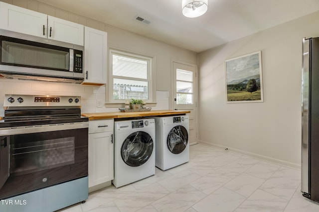 203 Hickory Rd, Bristol, TN 37620 - laundry area with light marble finish floors and washing machine and clothes dryer