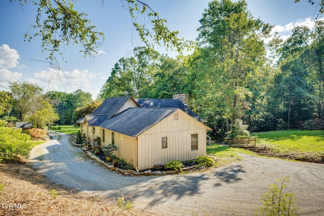 284 Bulldog Holw, Elizabethton, TN 37643 - view of home's exterior with a chimney, roof with shingles, driveway, and view of scattered trees
