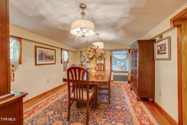 284 Bulldog Holw, Elizabethton, TN 37643 - dining area featuring wood finished floors, a chandelier, lofted ceiling, and cooling unit