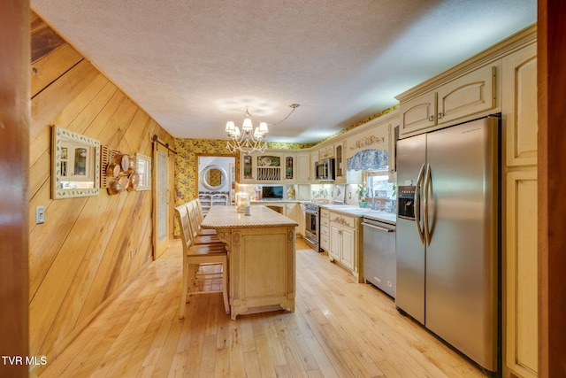 284 Bulldog Holw, Elizabethton, TN 37643 - kitchen featuring appliances with stainless steel finishes, light countertops, a chandelier, glass insert cabinets, and a textured ceiling