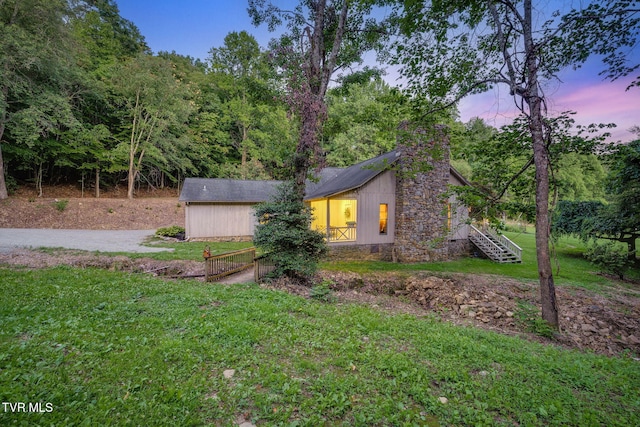 284 Bulldog Holw, Elizabethton, TN 37643 - property exterior at dusk featuring a yard, a chimney, and stairs
