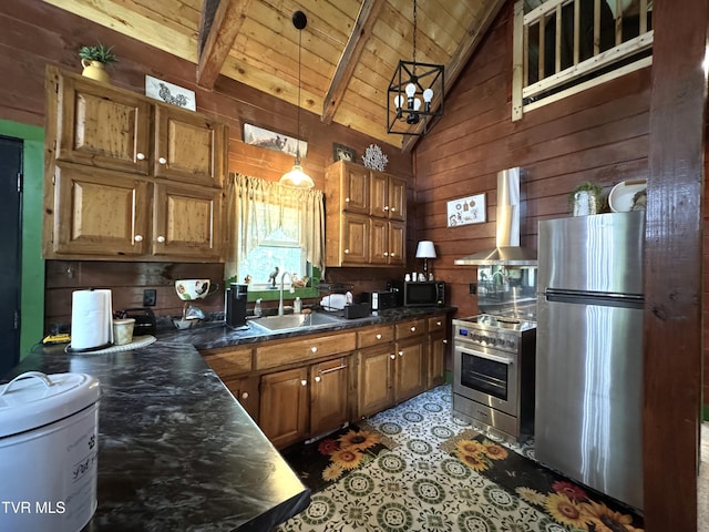 1014 Lightnen Rd, Parrottsville, TN 37843 - kitchen with stainless steel appliances, wall chimney range hood, dark countertops, wood walls, and brown cabinets