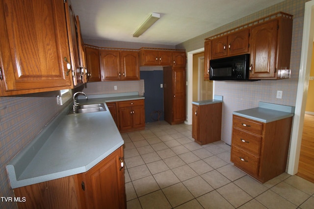 288 Hicks Rd, Piney Flats, TN 37686 - kitchen with black microwave, brown cabinetry, light tile patterned floors, and wallpapered walls
