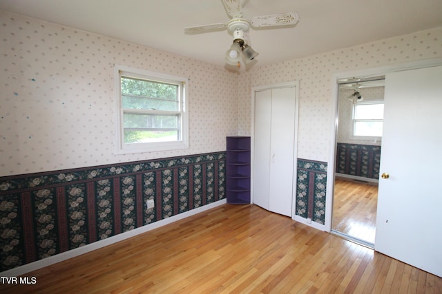288 Hicks Rd, Piney Flats, TN 37686 - unfurnished bedroom featuring wallpapered walls, hardwood / wood-style floors, and a ceiling fan