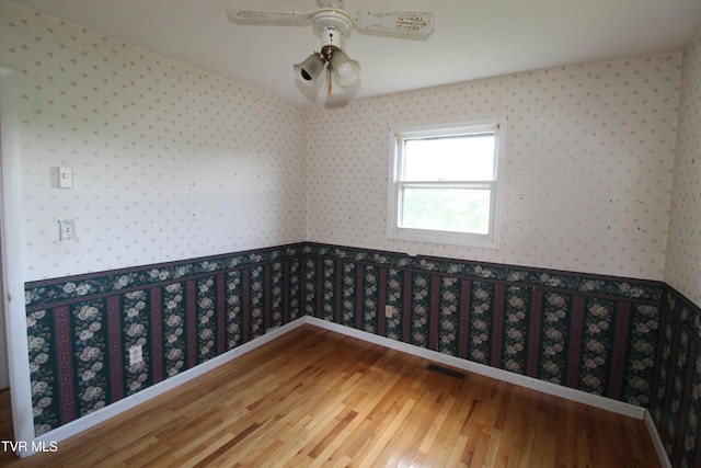 288 Hicks Rd, Piney Flats, TN 37686 - spare room with wallpapered walls, wood finished floors, and ceiling fan