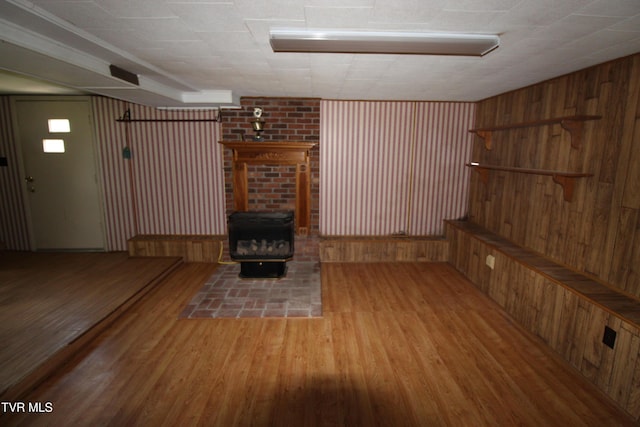 288 Hicks Rd, Piney Flats, TN 37686 - unfurnished living room with a wood stove, wood finished floors, and wooden walls