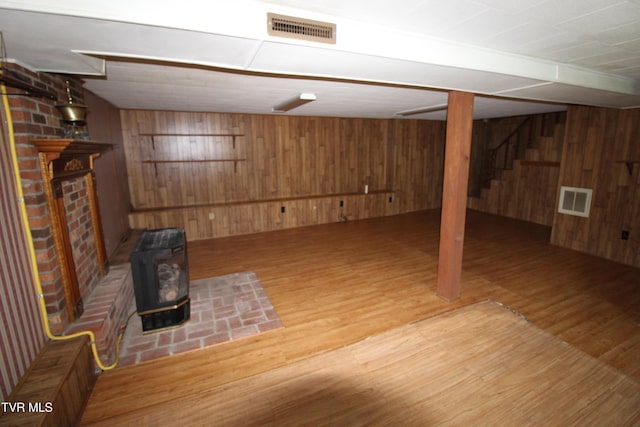 288 Hicks Rd, Piney Flats, TN 37686 - unfurnished living room featuring wooden walls, wood finished floors, and a wood stove