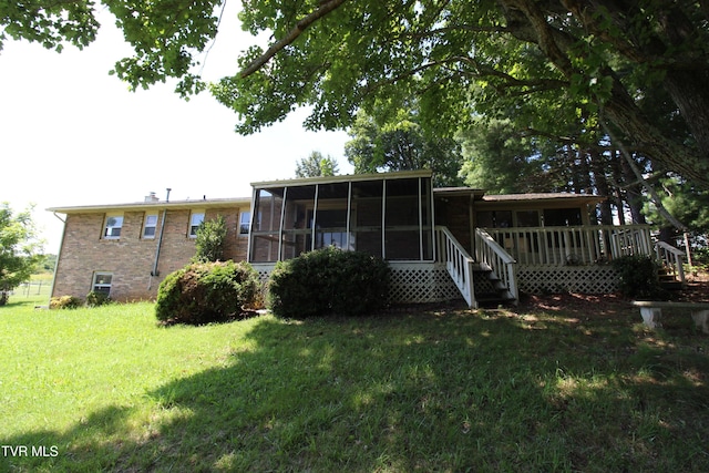 288 Hicks Rd, Piney Flats, TN 37686 - back of property featuring a sunroom, a yard, a wooden deck, and brick siding