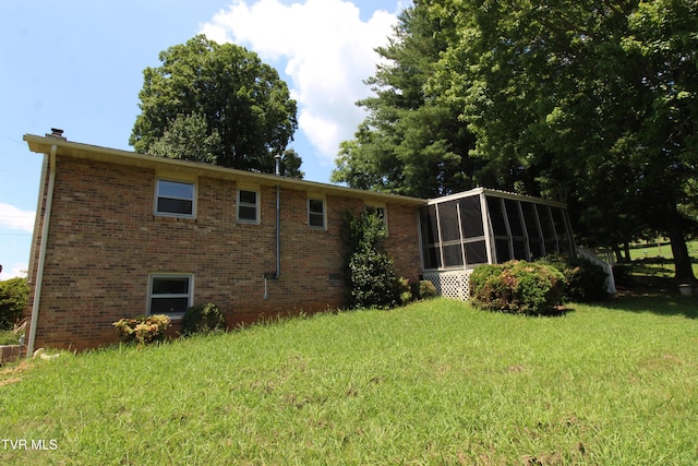 288 Hicks Rd, Piney Flats, TN 37686 - back of house featuring a sunroom, brick siding, and a yard