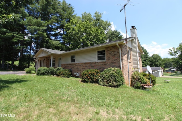 288 Hicks Rd, Piney Flats, TN 37686 - view of front of home with brick siding, a chimney, and a front lawn