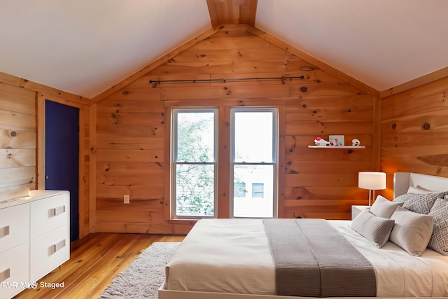 917 Pennsylvania Ave, Bristol, TN 37620 - bedroom featuring vaulted ceiling, wood walls, and light wood-style flooring