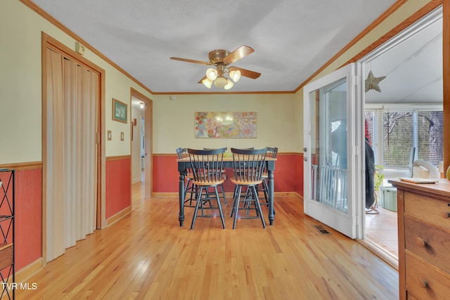 473 Oak Grove Rd, Gray, TN 37615 - dining room featuring ornamental molding, light wood-style floors, a ceiling fan, and wainscoting