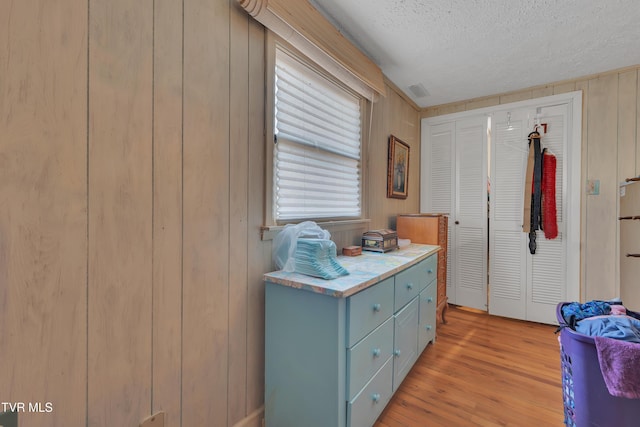 473 Oak Grove Rd, Gray, TN 37615 - bedroom featuring a textured ceiling, light wood finished floors, and wooden walls