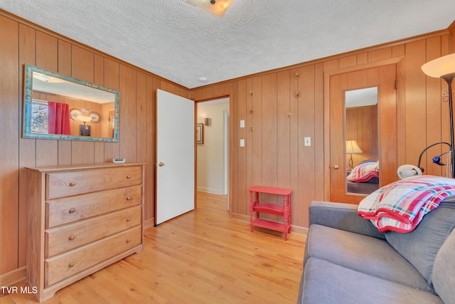 473 Oak Grove Rd, Gray, TN 37615 - living area featuring light wood-style floors, a textured ceiling, and wooden walls