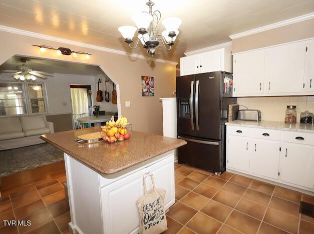 8087 Baptist Valley Rd, North Tazewell, VA 24630 - kitchen featuring black refrigerator with ice dispenser, crown molding, a chandelier, backsplash, and white cabinetry