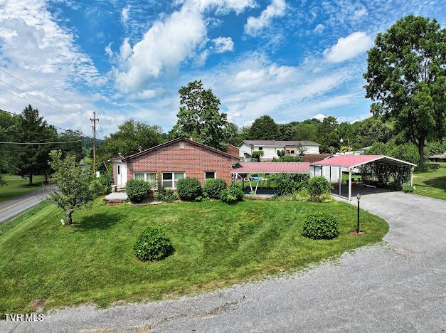 8087 Baptist Valley Rd, North Tazewell, VA 24630 - ranch-style home featuring a detached carport, a front lawn, and driveway