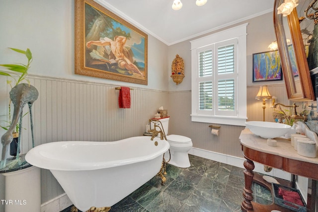 201 W Wanola Ave, Kingsport, TN 37660 - bathroom featuring a freestanding tub, marble finish floors, ornamental molding, a wainscoted wall, and vanity