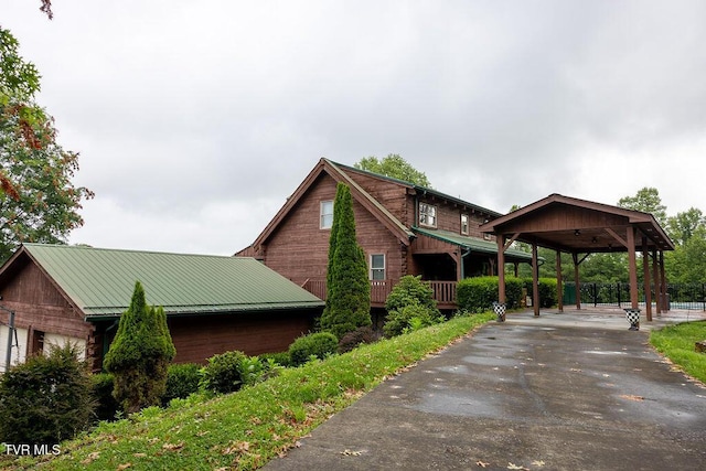 332 Undertaker Blvd, Clintwood, VA 24228 - view of side of home featuring driveway, a metal roof, a carport, and a standing seam roof