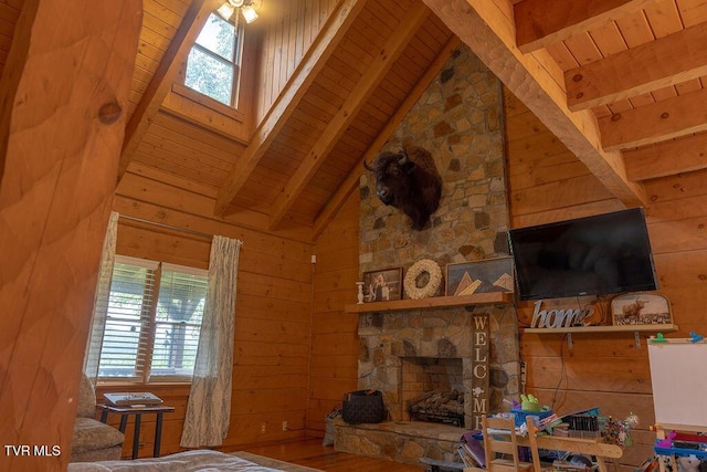 332 Undertaker Blvd, Clintwood, VA 24228 - living area featuring a wood ceiling with exposed beams, healthy amount of natural light, wooden walls, wood finished floors, and a stone fireplace