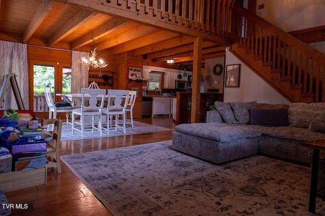 332 Undertaker Blvd, Clintwood, VA 24228 - living room featuring a chandelier, hardwood / wood-style flooring, beam ceiling, wood walls, and stairs