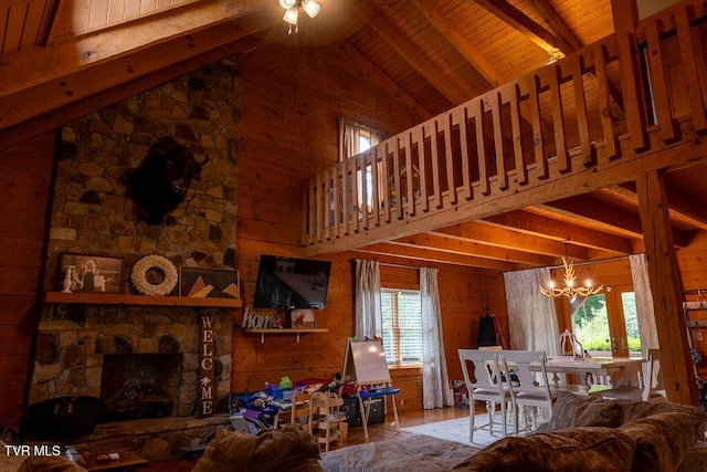 332 Undertaker Blvd, Clintwood, VA 24228 - living room featuring a chandelier, a wooden ceiling with exposed beams, wooden walls, a ceiling fan, and wood finished floors