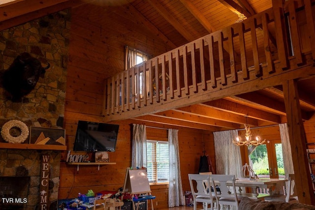 332 Undertaker Blvd, Clintwood, VA 24228 - dining space featuring healthy amount of natural light, a chandelier, a wooden ceiling with exposed beams, wood walls, and high vaulted ceiling