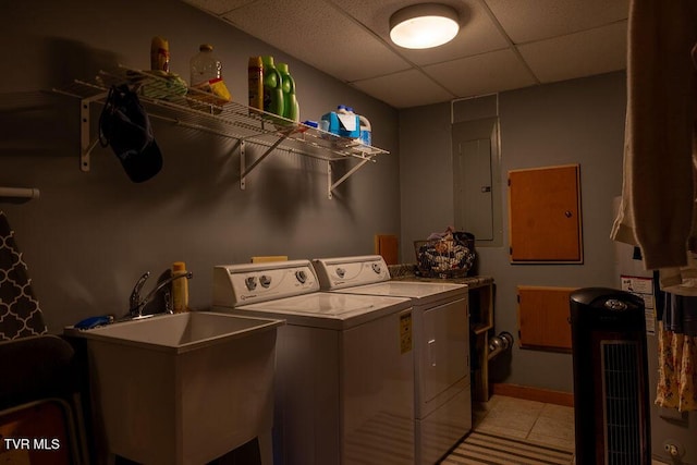 332 Undertaker Blvd, Clintwood, VA 24228 - laundry room with washing machine and dryer, light tile patterned floors, and electric panel
