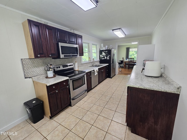 1358 Bristol Hwy, Elizabethton, TN 37643 - kitchen with stainless steel appliances, ornamental molding, light countertops, light tile patterned flooring, and decorative backsplash